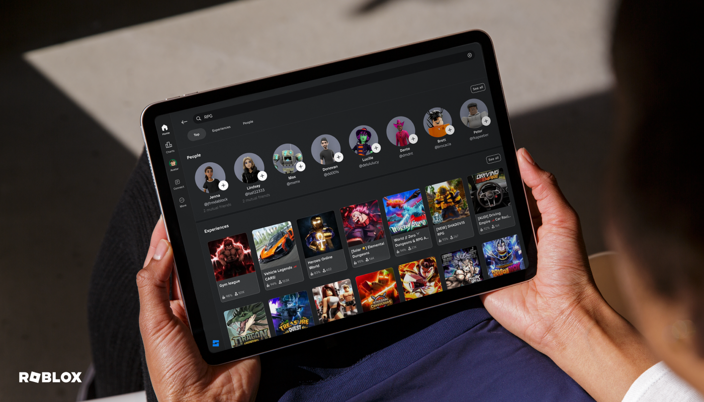 Hands holding tablet with Roblox app