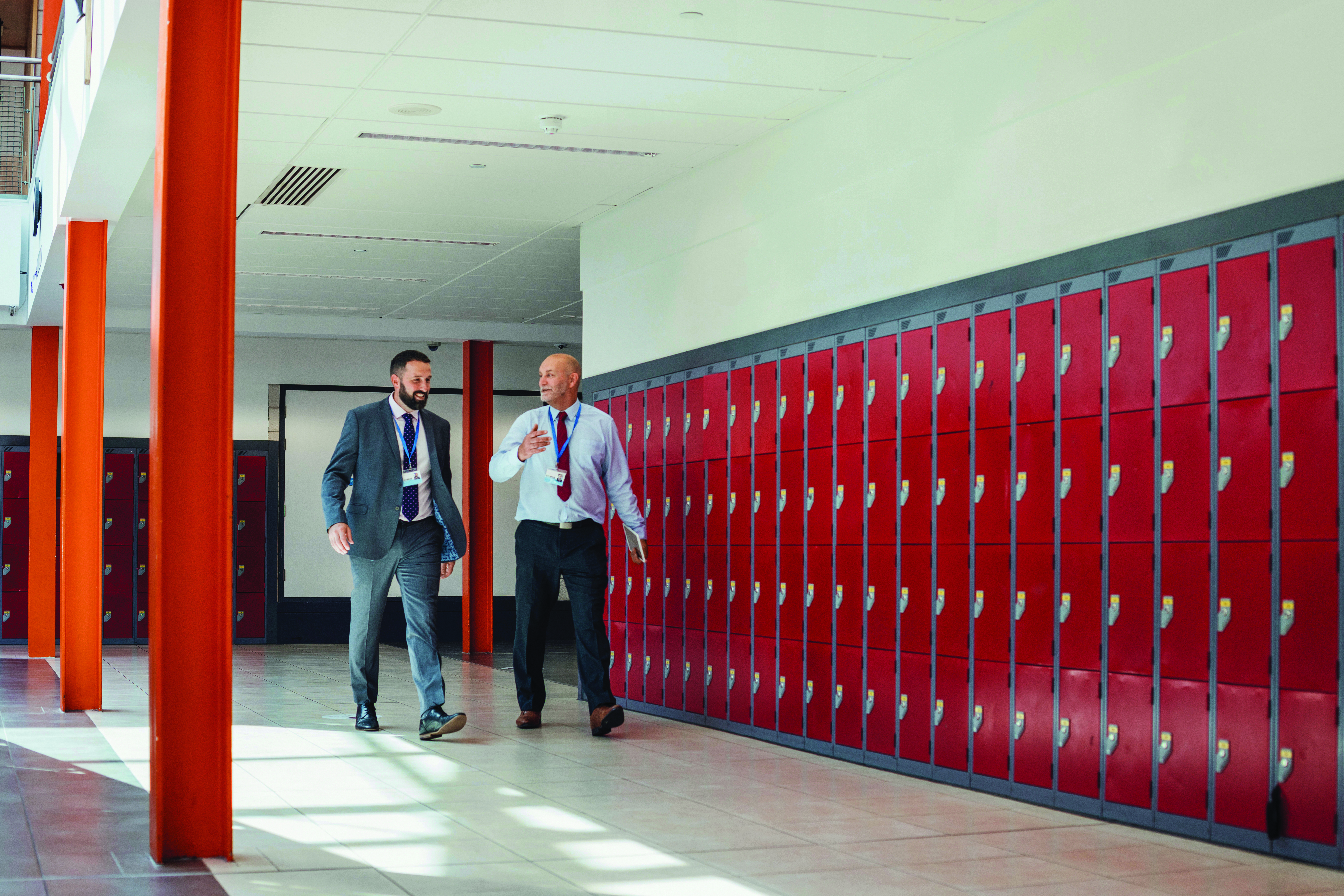 Educators walking down school hallway
