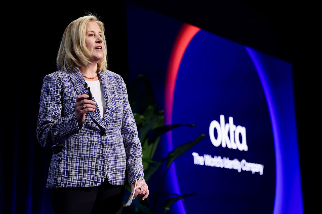 Amy Johanek in a blue tweed blazer delivering a presentation.